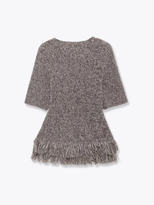 Detail of the chunky knit texture and long fringe hem on the short-sleeved top