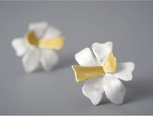 Macro shot of bicolour petal stud earring with fine matte metallic texture detail