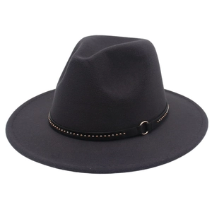 Detail of black fedora hat featuring metal rivets and a gold ring buckle on the leather band