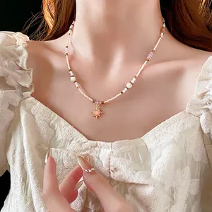 18K gold plated beaded sunflower necklace with pink stone on model