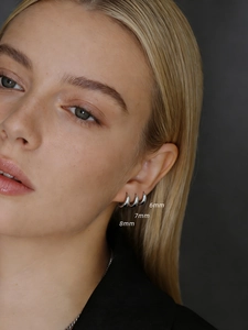 Close-up of 925 sterling silver hoop earrings in 6mm, 7mm, and 8mm sizes on ear