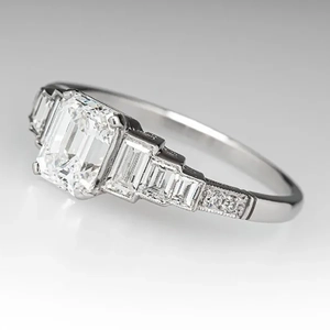 Classic silver ring with emerald-cut center stone and baguette diamonds on sides
