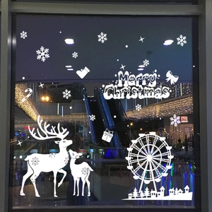 White Christmas window decals featuring Merry Christmas text, reindeer, and snowflakes