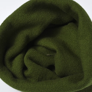 Elastic knit winter hat for women in deep olive green showing warm textured fabric weave