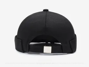Detail of adjustable silver metal buckle on black cotton docker hat with twill texture