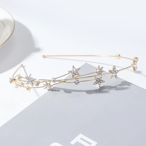 Elegant gold headband featuring sparkling rhinestone stars in a vintage court style
