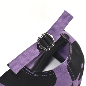 Adjustable purple and black cow print baseball cap with metallic buckle back closure