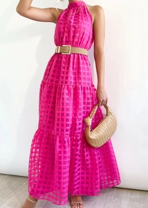 Detail of fuchsia tiered maxi dress with checkered texture and beige belt accessory