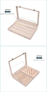Detailed view of beige velvet jewelry boxes for earrings and rings with glass window