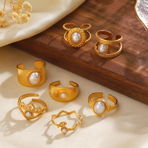 7-piece gold stainless steel pearl ring set with sunburst and braided designs