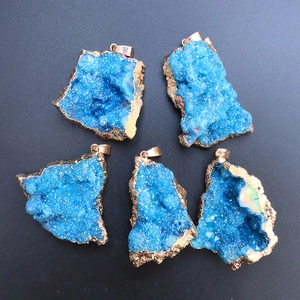 Five blue geode crystal pendants with golden edges on a black background