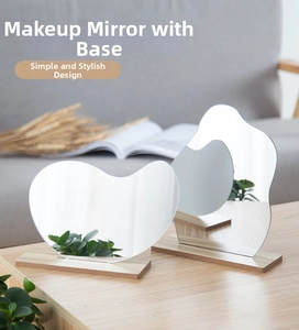 Minimalist irregular acrylic makeup mirror set with rectangular wooden base on table