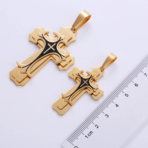 Macro detail of triple-layer gold stainless steel cross pendants with scale reference