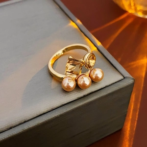 Detail of gold-plated ring featuring champagne pearls and amber yellow crystals
