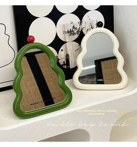 Detail of Christmas tree shaped makeup mirrors with wavy frames and festive printing