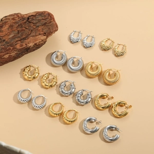 Detailed view of assorted 14K gold plated geometric hoop earrings on a neutral background