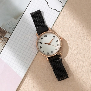 Detail of rose gold case and black stainless steel mesh magnetic band on white dial watch