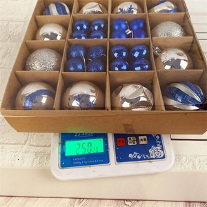 Christmas ornaments set in box weighing 250g on a digital scale for delivery