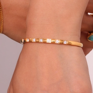 Detailed macro view of 18K gold plated bracelet with micro-pocked zircons on wrist