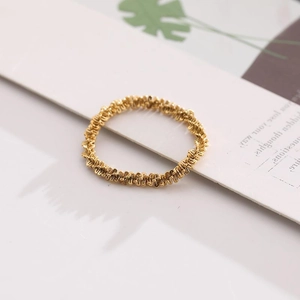 Macro detail of the 18K gold plated ring featuring unique wrinkled metal texture