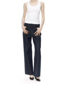Women's slim fit white ribbed tank top paired with wide-leg blue denim jeans