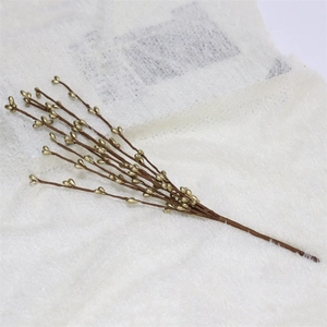 Antique gold artificial berry branch for Christmas home decor on white fabric