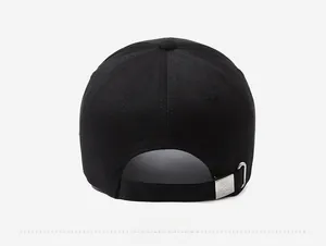 Detail of black baseball cap back with adjustable strap and silver metal buckle