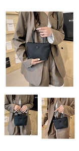 Détail d'un sac seau en nylon noir avec boucle métallique et double poignée élégante
