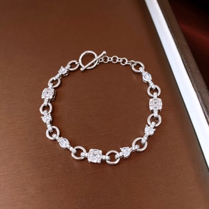 Macro shot of silver zircon bracelet featuring square links and a classic toggle clasp