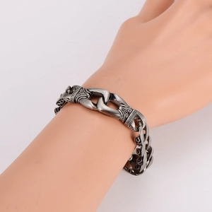 Macro detail of vintage silver bracelet featuring embossed European totem engravings