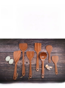 Detailed seven-piece African ebony wood cooking utensil set with natural grain texture