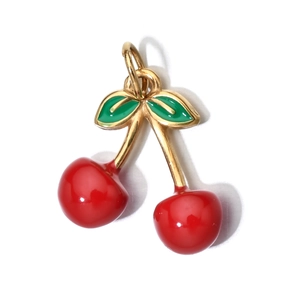 Detail of red cherry and green leaf enamel pendant with gold loop on white background