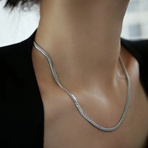 Men's minimalist silver stainless steel flat snake bone chain necklace worn by model