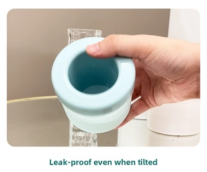 Leak-proof test of light blue silicone ice cube maker showing airtight seal when tilted