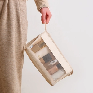 Large capacity beige mesh travel toiletry bag with hand strap and travel label