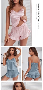 Detail of silk satin pajamas set with ruffle shorts and delicate straps in soft colors