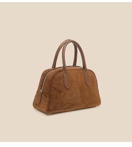 Detail of premium brown suede Boston bag showing smooth leather trim and silver zipper
