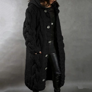 Detail of chunky cable knit texture and large buttons on long hooded cardigan