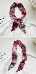 Artistic oil painting style silk scarf worn as a bow tie on a white shirt collar