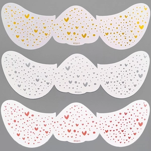 Detailed view of heart pattern freckle tattoo stickers in yellow, grey, and pink styles