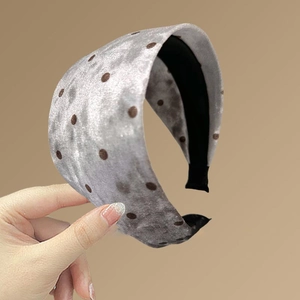 Détail d'un serre-tête large en velours gris argenté à pois marrons et doublure antidérapante