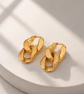 Macro view of chunky 18K gold plated curb chain link earrings with metallic luster