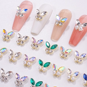 Macro detail of 3D alloy butterfly nail charms with colorful zircon and pearls