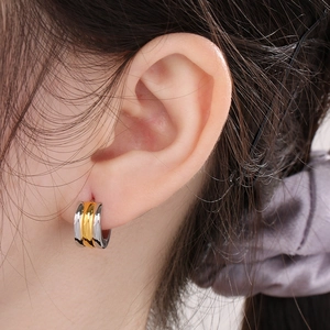 Close-up of three-row two-tone gold and silver 18K plated stainless steel hoop earrings
