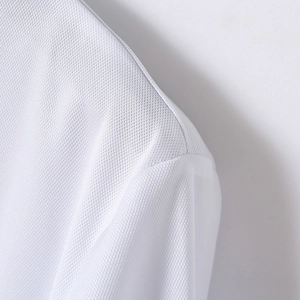 Macro shot of white breathable pique fabric texture and seam details on the polo shirt