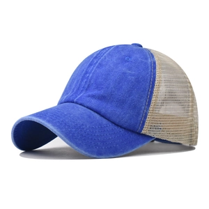 Detailed side view of washed blue canvas baseball cap with breathable cream mesh back