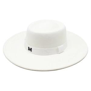Detail of white wide brim wool fedora hat featuring a black metallic M logo on the ribbon