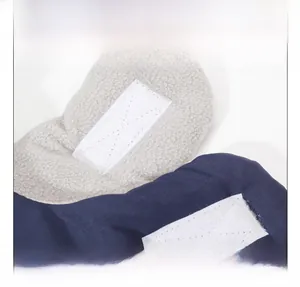 Detail view of winter hat featuring adjustable white Velcro strap and soft fleece lining