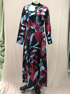 Detail of floral printed satin long dress with stand collar and cinched waist on mannequin