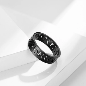Nordic Viking rune ring in black titanium steel shown on a minimalist white geometric stage